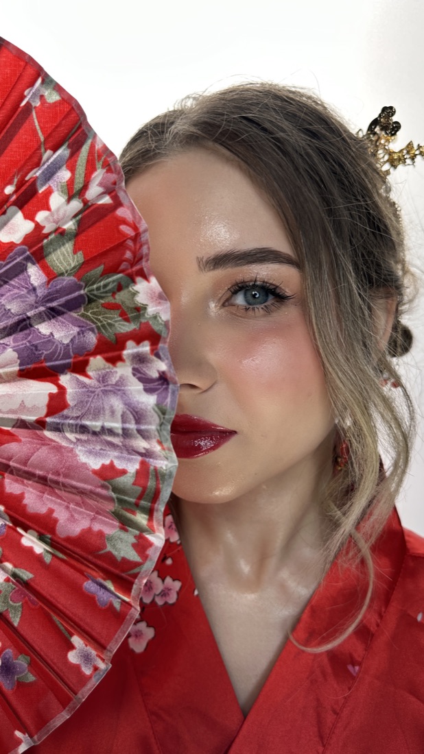 Makeup portrait with red lips and a floral fan
