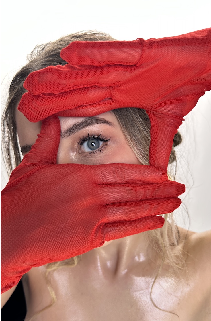 Blue eye framed by red gloves, original Beauty by O’Shade work